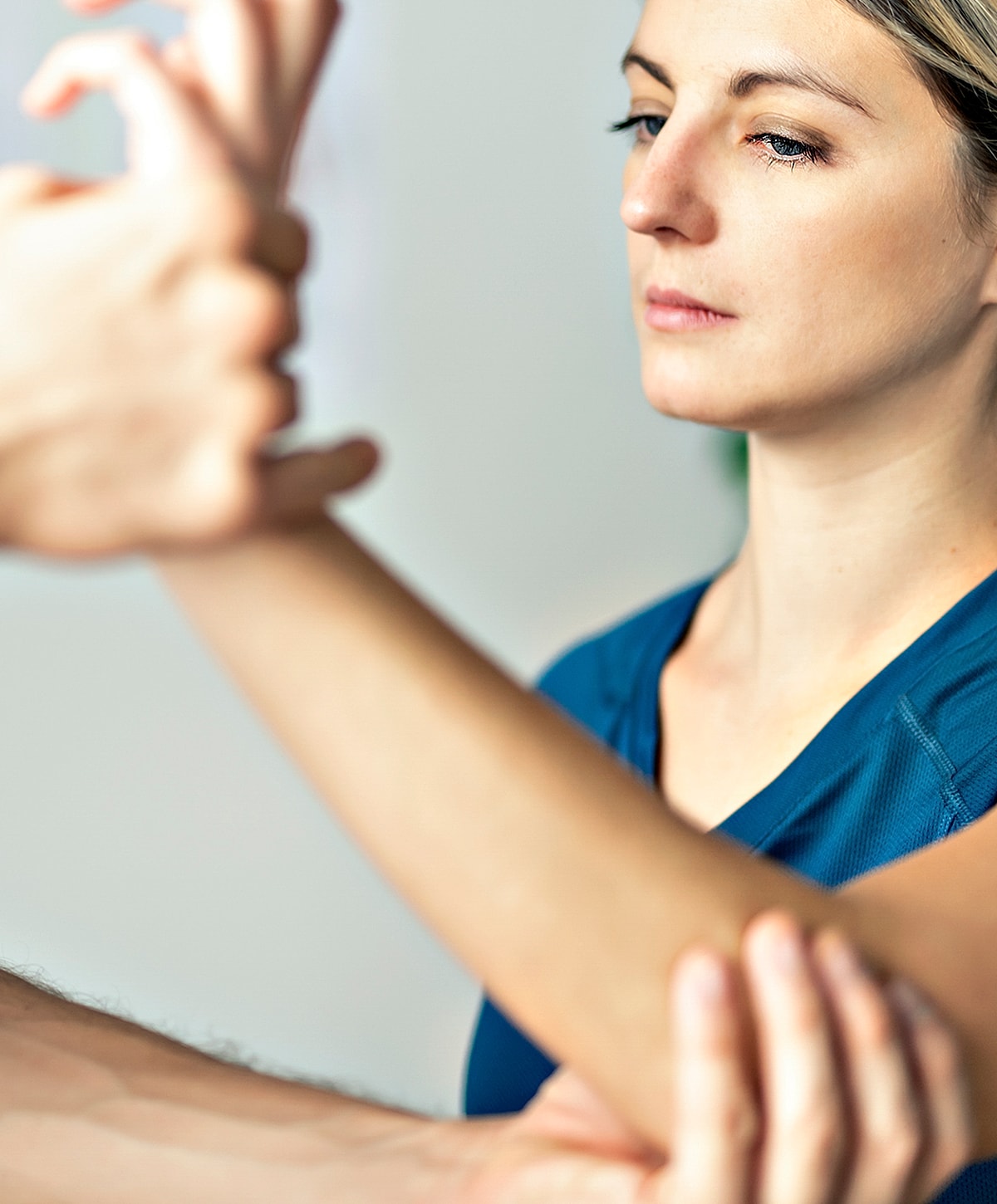 Person receiving therapy or guidance on arm position.