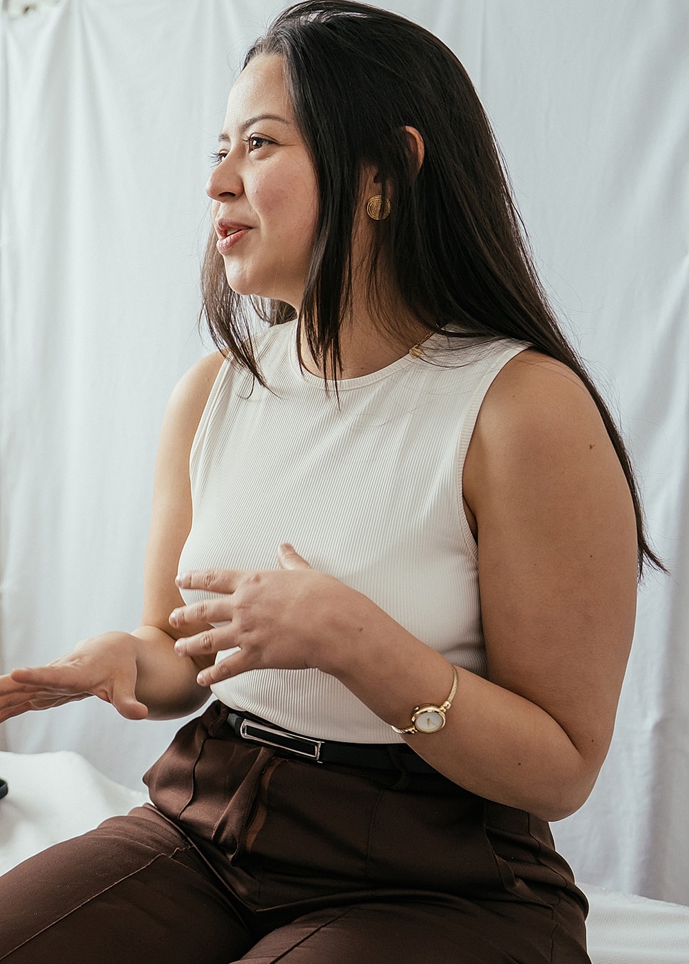 Woman conversing with hands gesturing, natural expression.