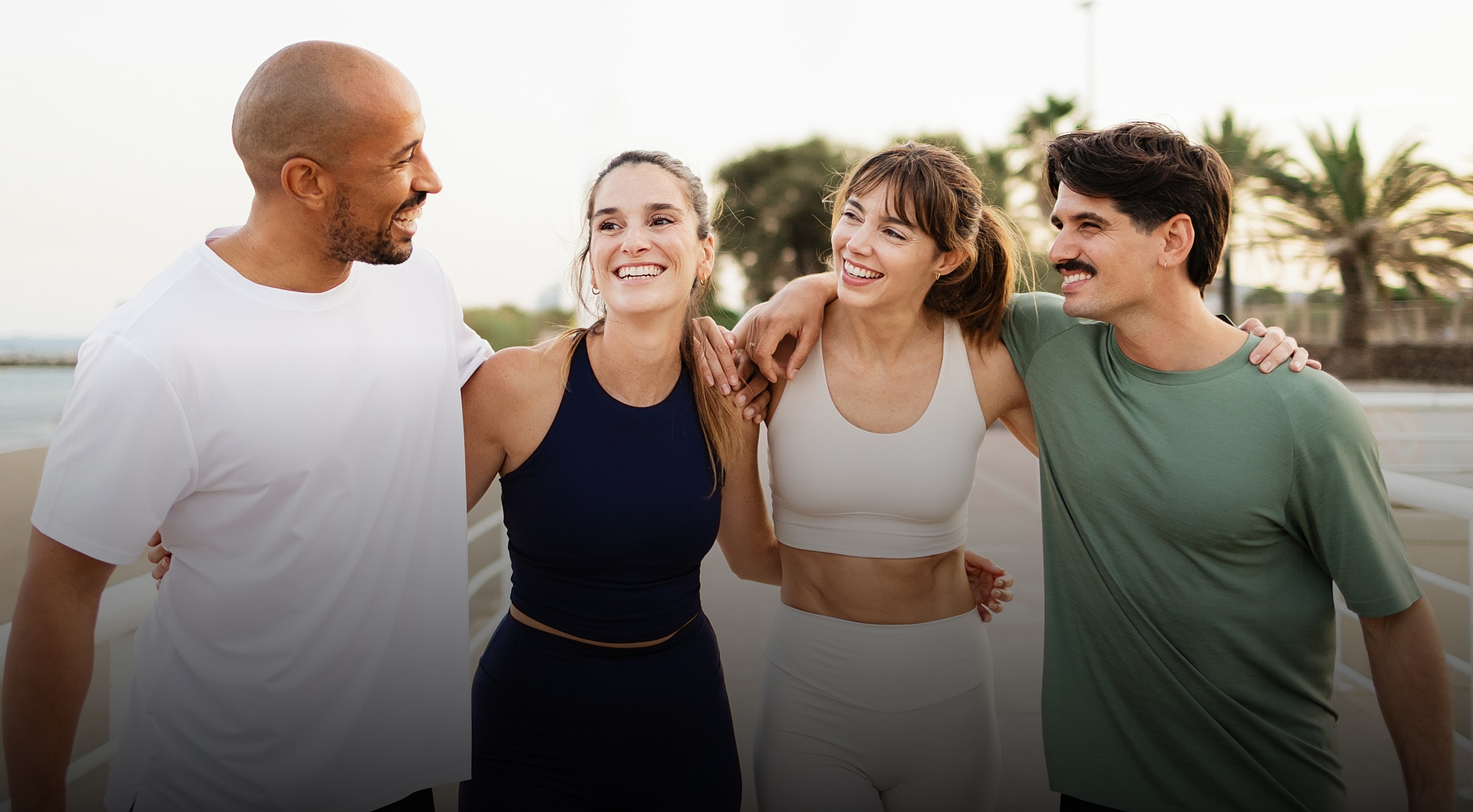 Smiling friends enjoying fitness outdoors together.
